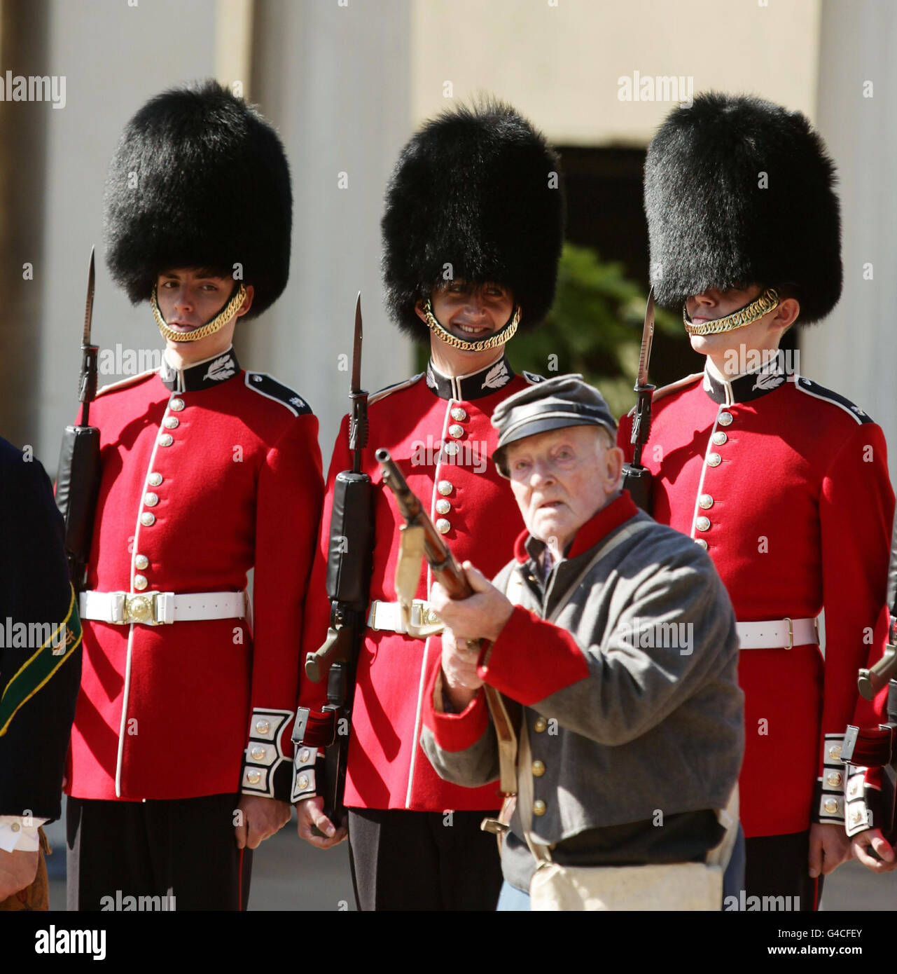 Joseph Francis, aged 91 from Kent, of The Southern Skirmish Association (SoSkAn) American Civil War Re-enactment Society with soldiers from the Grenadier Guards, during the launch of The British Military Tournament at Wellington Barracks in central London. Stock Photo