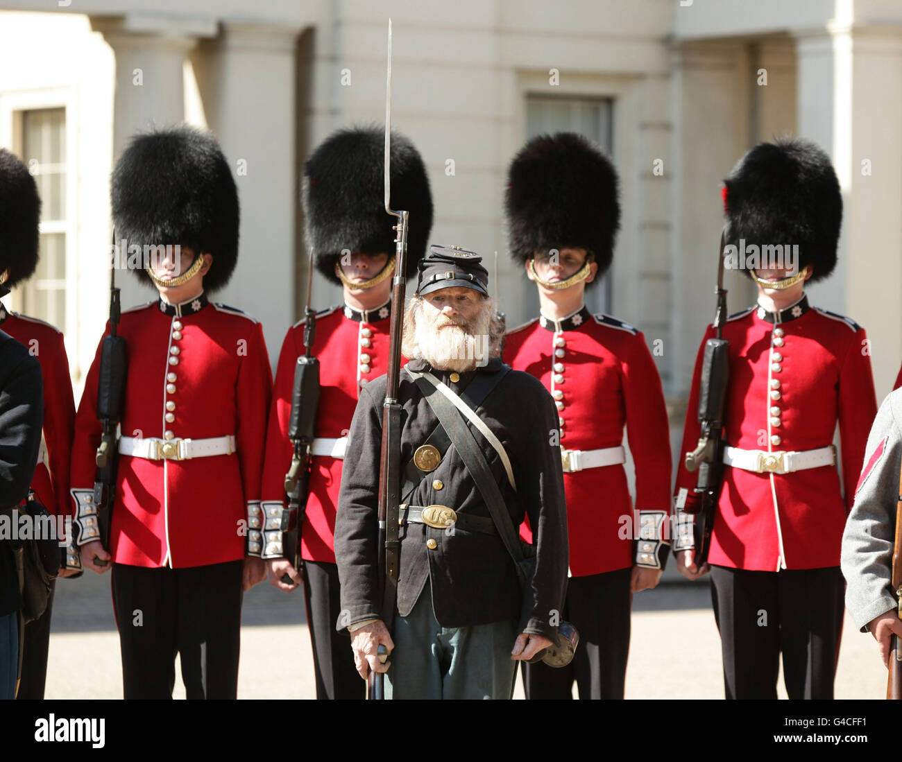 A members of The Southern Skirmish Association (SoSkAn) American Civil War Re-enactment Society with soldiers from the Grenadier Guards, during the launch of The British Military Tournament at Wellington Barracks in central London. Stock Photo