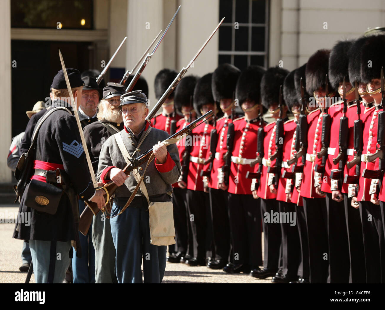 Members of The Southern Skirmish Association (SoSkAn) American Civil War Re-enactment Society with soldiers from the Grenadier Guards, during the launch of The British Military Tournament at Wellington Barracks in central London. Stock Photo