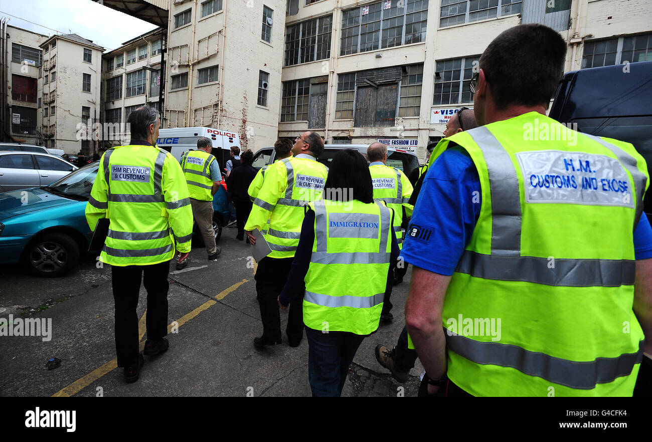 Immigration and Custom and Excise officers conduct a search during a multi-agency operation at the former Imperial Typewriters building on East Park Road in Leicester where several businesses were suspected of employing illegal workers. Stock Photo