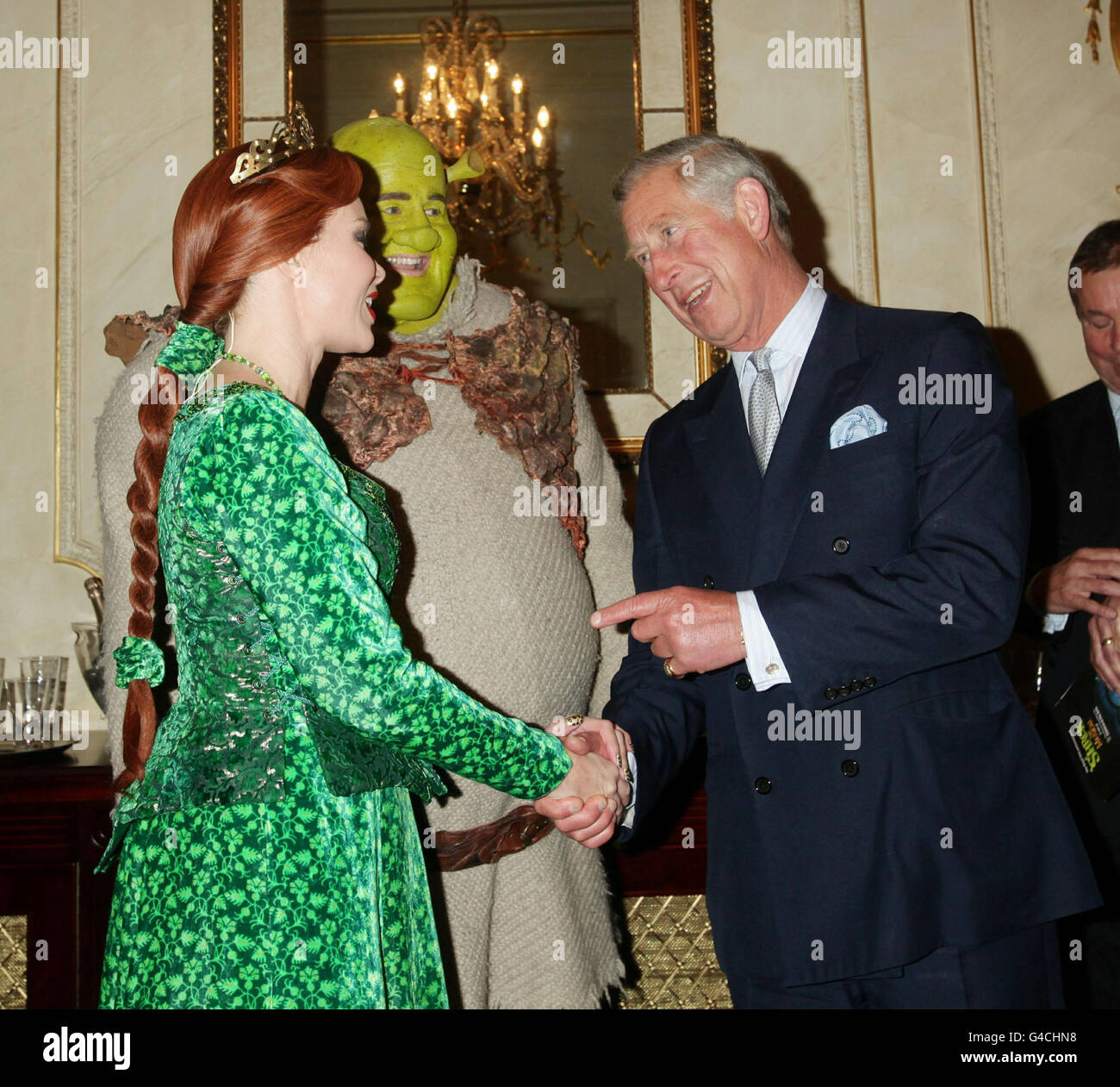 The Prince of Wales meets Nigel Lindsay as Shrek and Amanda Holden as Princess Fiona, before a special performance of Shrek The Musical at the Theatre Royal in Drury Lane, London. Stock Photo