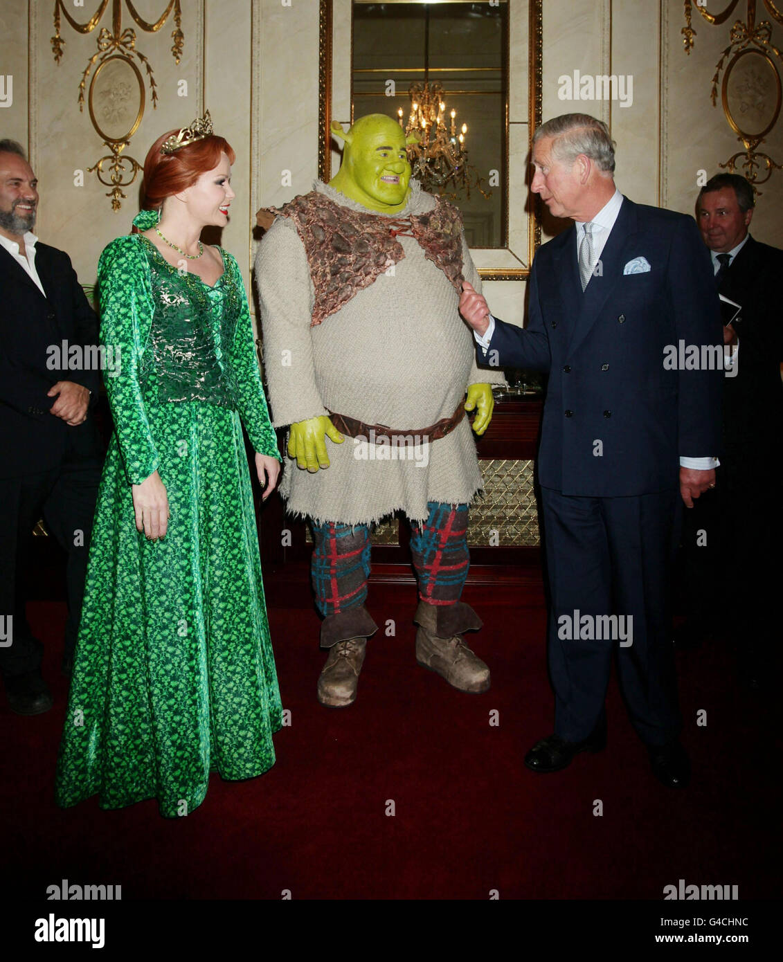 The Prince of Wales meets Nigel Lindsay as Shrek and Amanda Holden as Princess Fiona, as Sam Mendes (left) looks on before a special performance of Shrek The Musical at the Theatre Royal in Drury Lane, London. Stock Photo