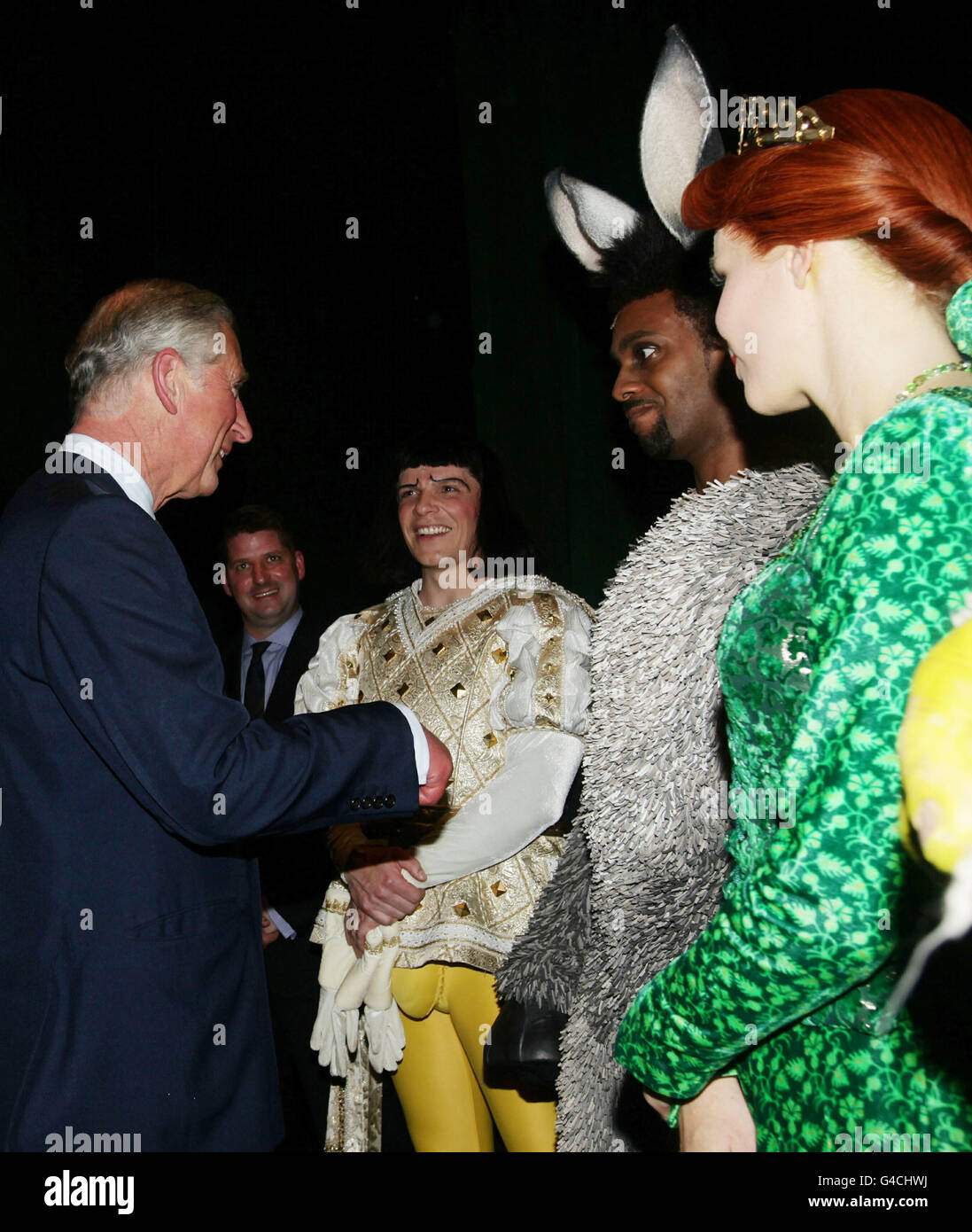 The Prince of Wales meeting (left to right) Nigel Harman as Lord Farquaad, Richard Blackwood as Donkey and Amanda Holden as Princess Fiona, after a special performance of Shrek The Musical at the Theatre Royal in Drury Lane, London. Stock Photo