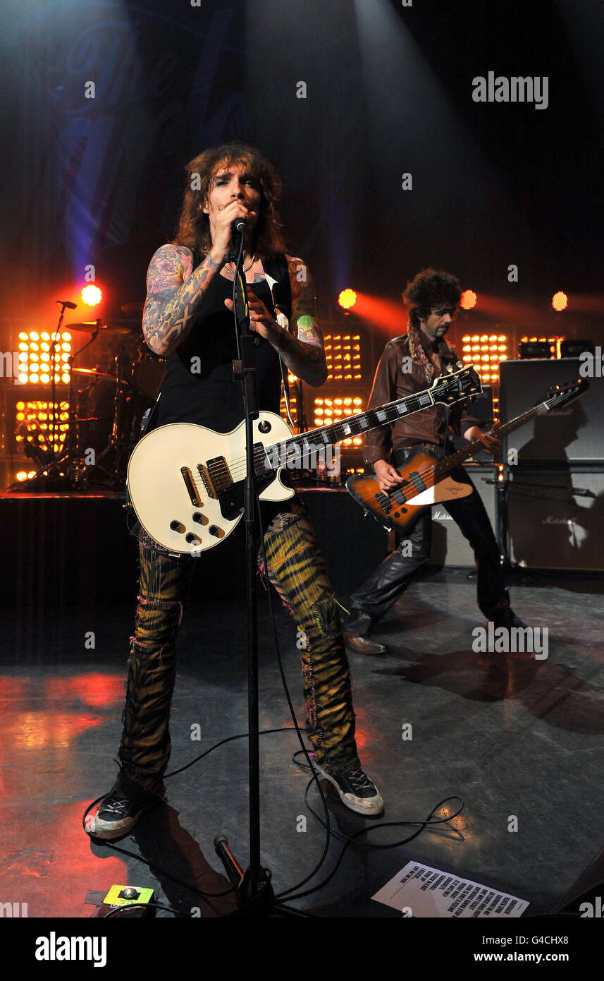 Justin Hawkins (left) and Frankie Poullain of The Darkness perform on stage at the O2 Shepherd's Bush Empire in west London, the band's first show in London after reuniting. Stock Photo