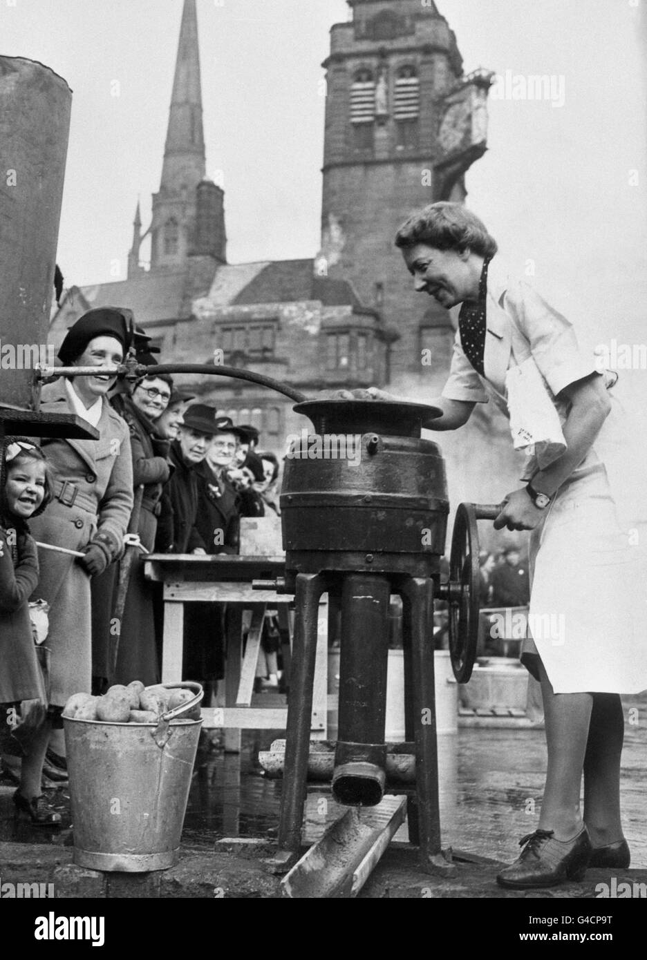 A lady operates a semi-mobile canteen on the streets of Coventry following Lord Woolton's statement that the Ministry of Food had completed arrangements for feeding 20 percent of the population of Great Britain and Northern Ireland in the event of an emergency. Plans had been made for providing over 20,000,000 hot meals a day or 5,000,000 full course meals. Stock Photo
