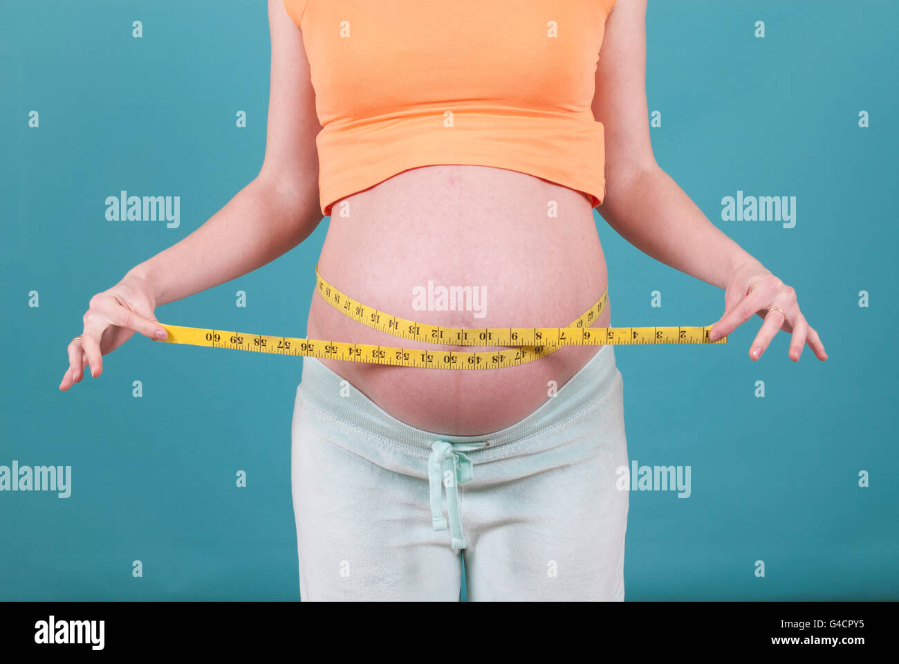 Pregnant woman measuring belly with tape measure Stock Photo - Alamy Pregnant woman measuring belly with tape measure Stock Photo - Alamy