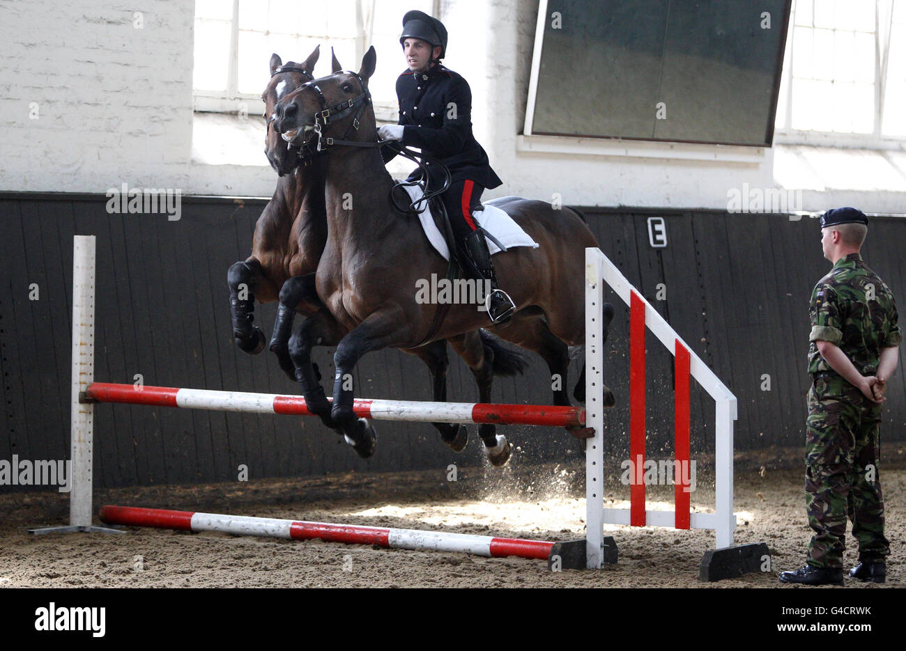 Elizabeth Ii Rider A rider jumps two horses during a display for Queen Elizabeth II in St ...