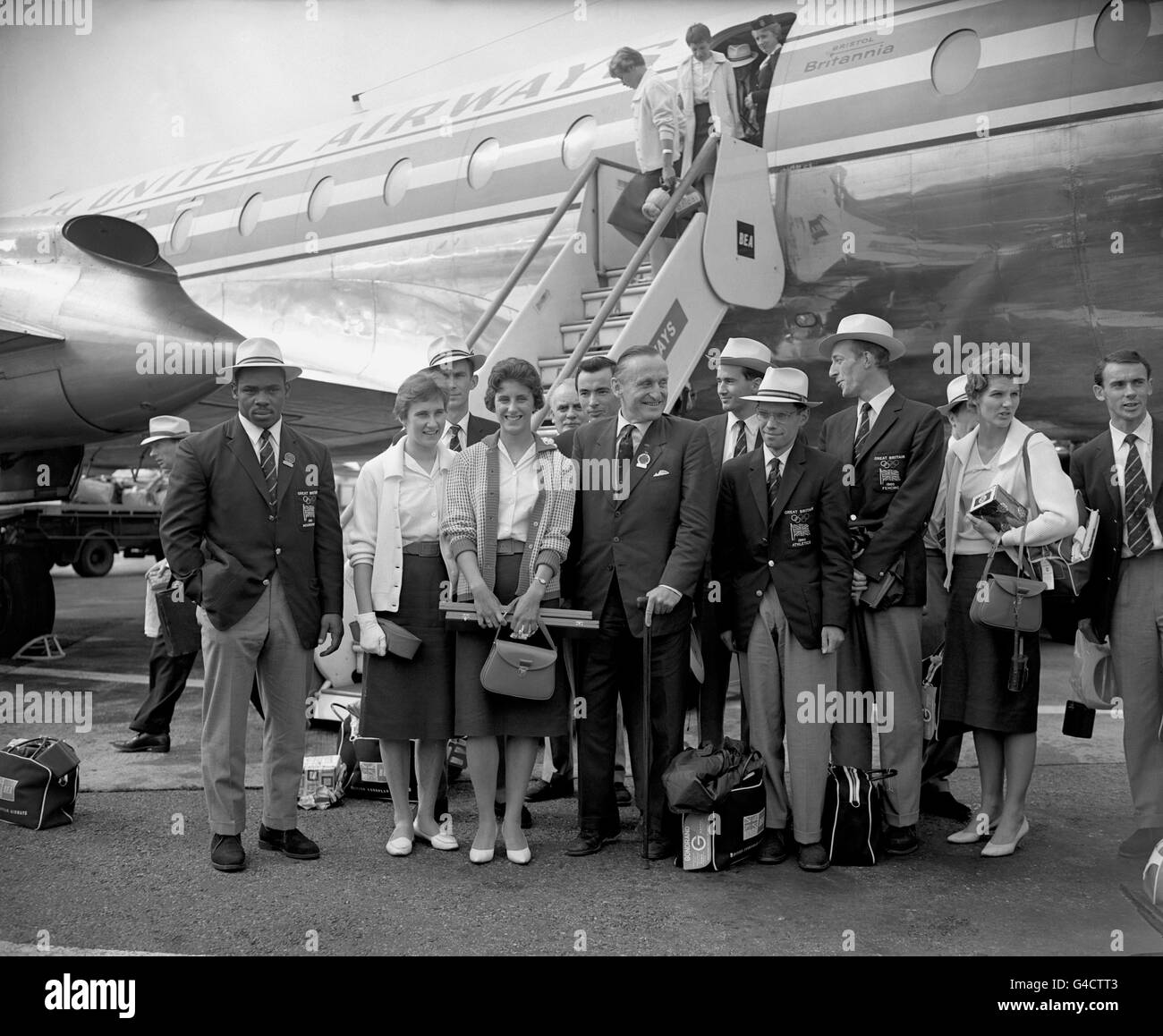 (L-R) Some of the British medalists upon their arrival at London Airport: weightlifter Louis Martin (bronze), high jumper Dorothy Shirley (silver), 100m runner Dorothy Hyman (silver), Lord Burghley, The 6th Marquis of Exeter, 50km walker Don Thompson (gold), a fencer and 80m hurdler Carol Quinton (silver) Stock Photo