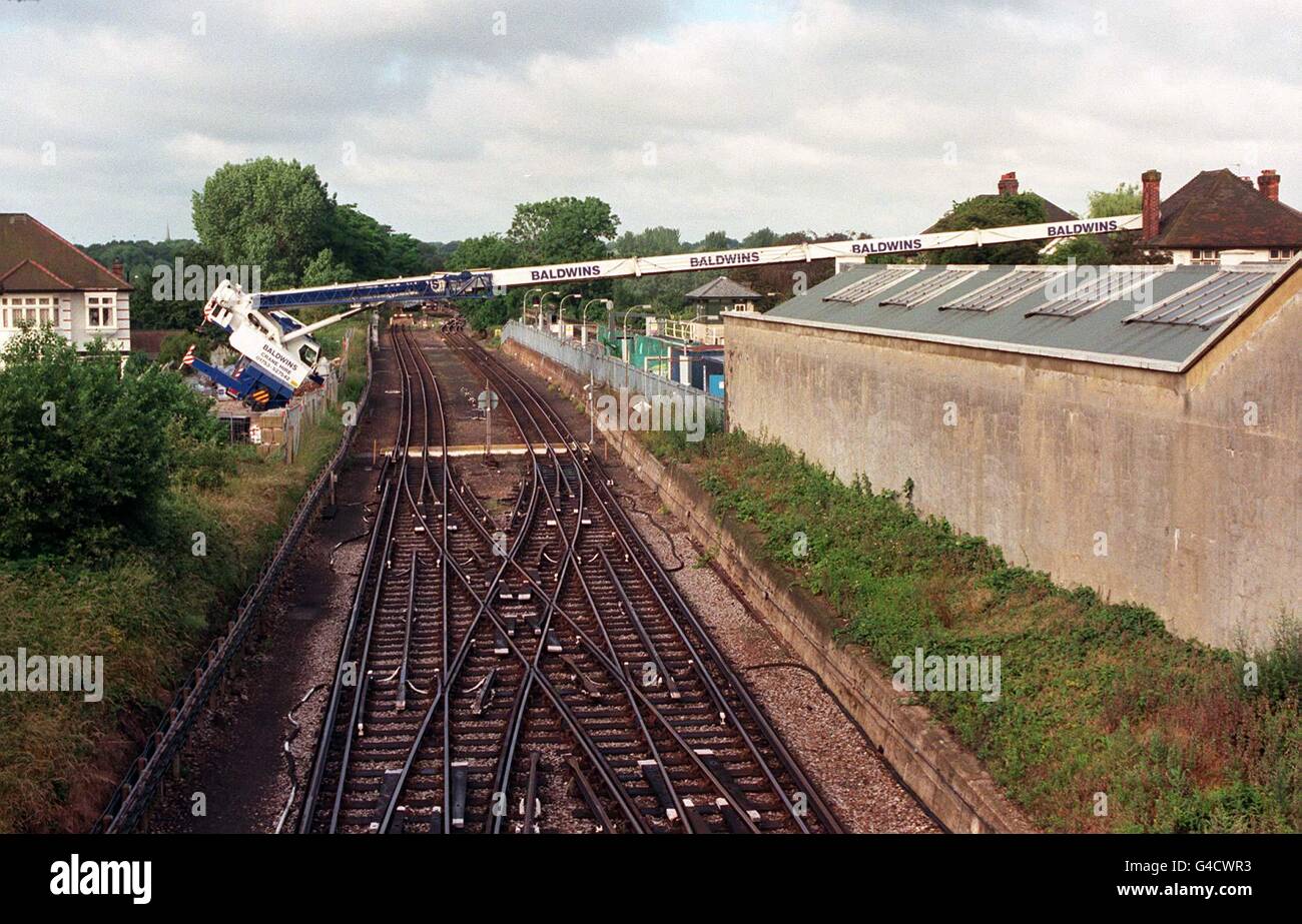An 80ft crane lies across the rails at Boston Vale, west London, after collapsing and landing on a house. The crane also fell across tube lines and will cause delays on the Piccadilly Line, a main route to Heathrow Airport. Stock Photo