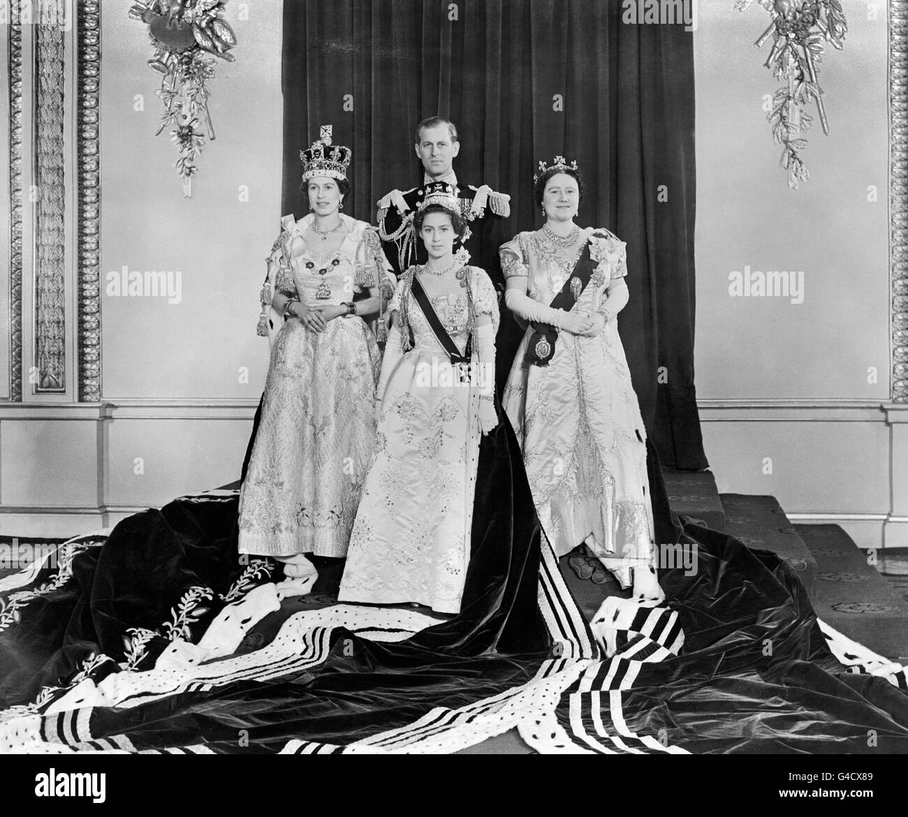 Queen Elizabeth II, left, at Buckingham Palace after her Coronation at Westminster Abbey. With her are the Duke of Edinburgh, back, Princess Margaret, front, and the Queen Mother, right. Stock Photo