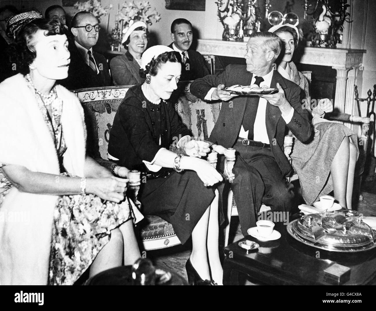 The Duke and Duchess of Windsor watch the coronation of Queen Elizabeth II  on the television screen at the Paris home of Margaret Biddle (right), the  American millionairess Stock Photo - Alamy