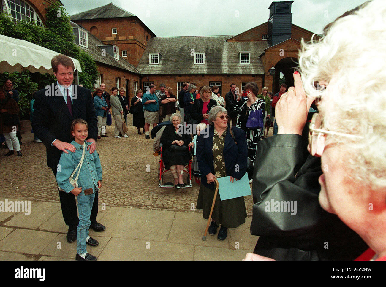 PA NEWS 1/7/98 EARL SPENCER STANDS WITH A VISITOR ON THE FIRST DAY THAT THE SPENCER FAMILY ESTATE AT ALTHORP, WITH A DIANA, PRINCESS OF WALES EXHIBITION, URN AND DORIC TEMPLE, WAS OPENED TO THE PUBLIC. Stock Photo