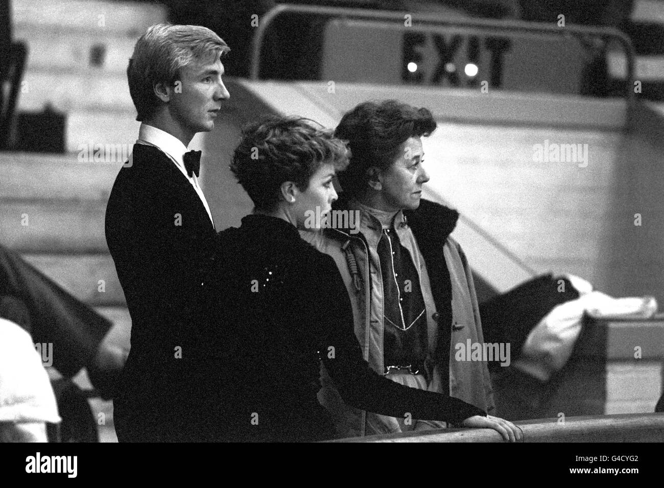 British Ice Dancers Christopher Dean (l) and partner Jayne Torvill (c) watch on with their coach Betty Callaway (r) as they win the Gold Medal in the European Figure Skating Championships Stock Photo