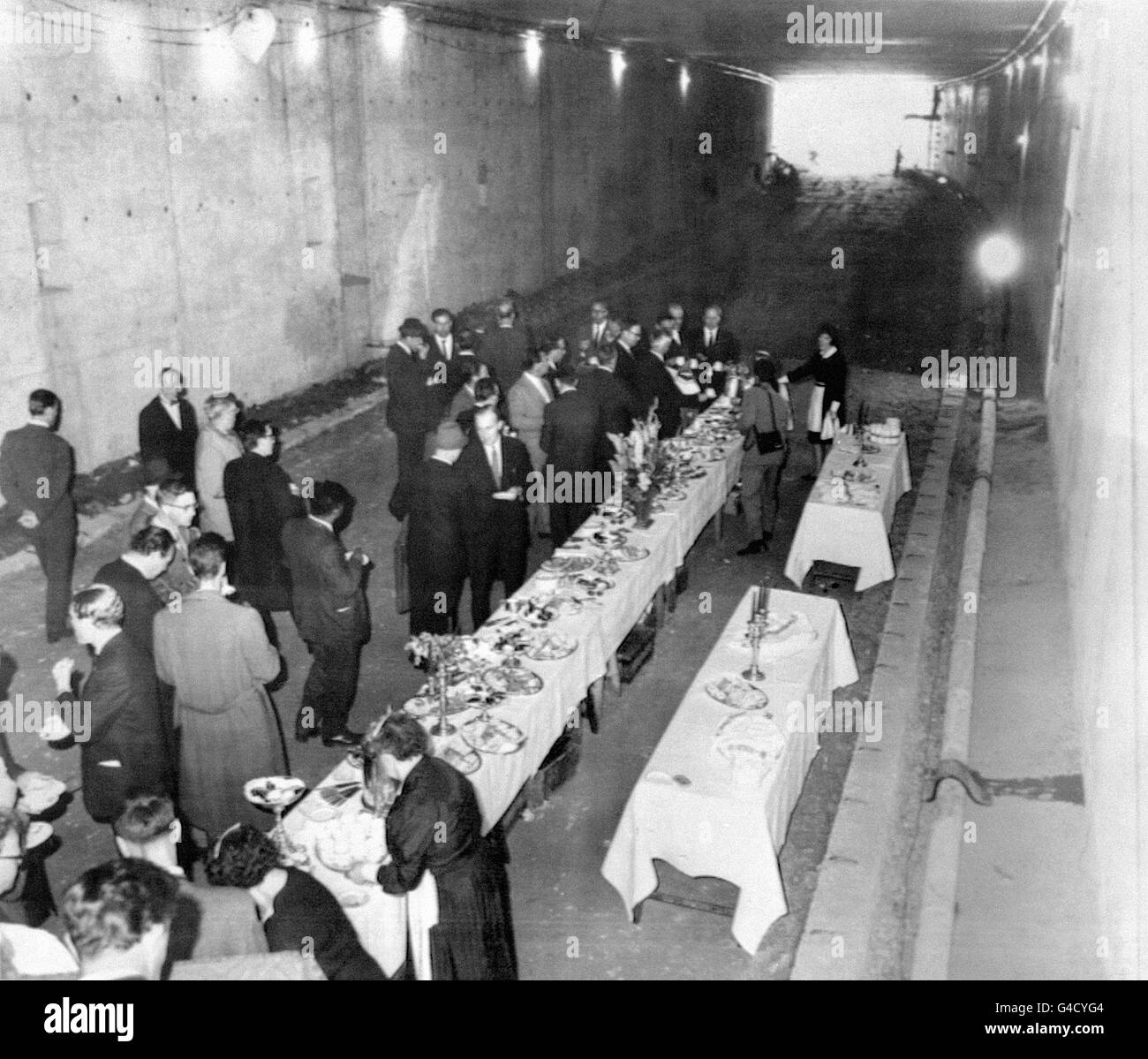 A tea party takes place in the tunnel that forms part of the new inner ring road of Leeds. It has been made so that the infirmary and the university can build above it. Mr Wynne Jones, of the Leeds Corporation Engineering Department, thought up the idea of the tea party. Stock Photo