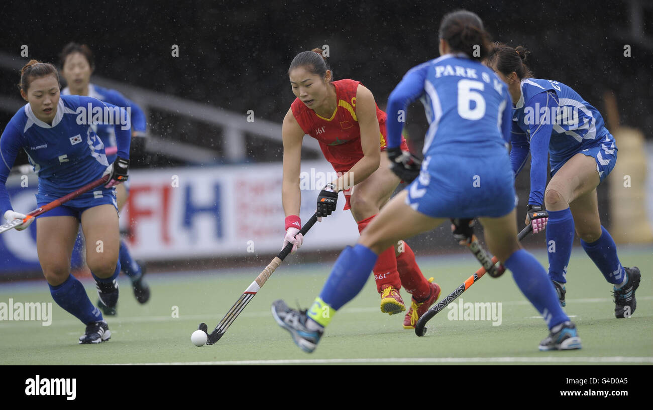 China's Yudioa Zhao (centre) runs at the South Korean defence during their opening game in the Rabo FIH Women's Champions Trophy at the Wagener Stadium, Amsterdam Stock Photo