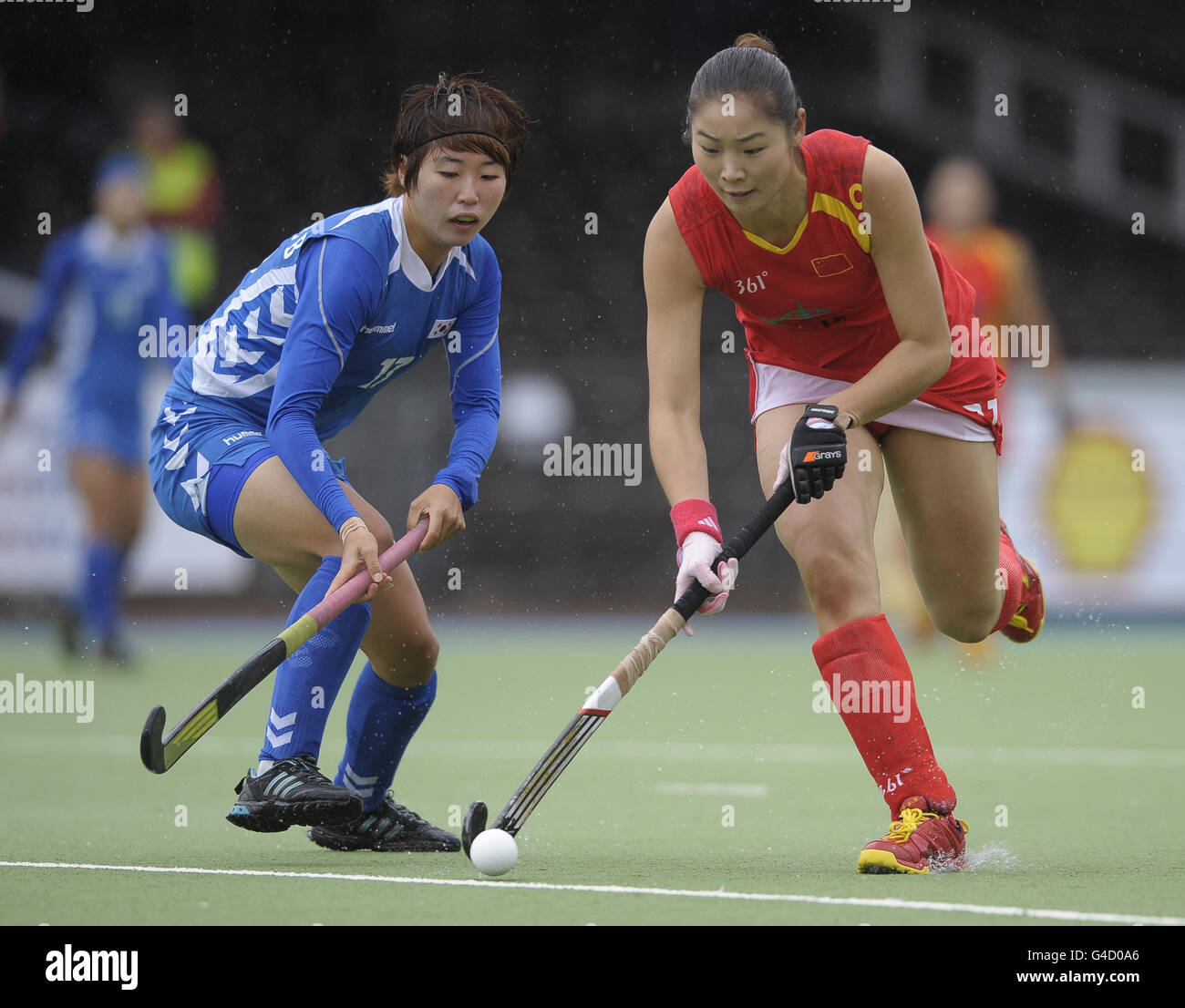 China's Yudioa Zhao (right) challenges with South Korea's Eun Bi Cheon during their opening game in the Rabo FIH Women's Champions Trophy at the Wagener Stadium, Amsterdam Stock Photo