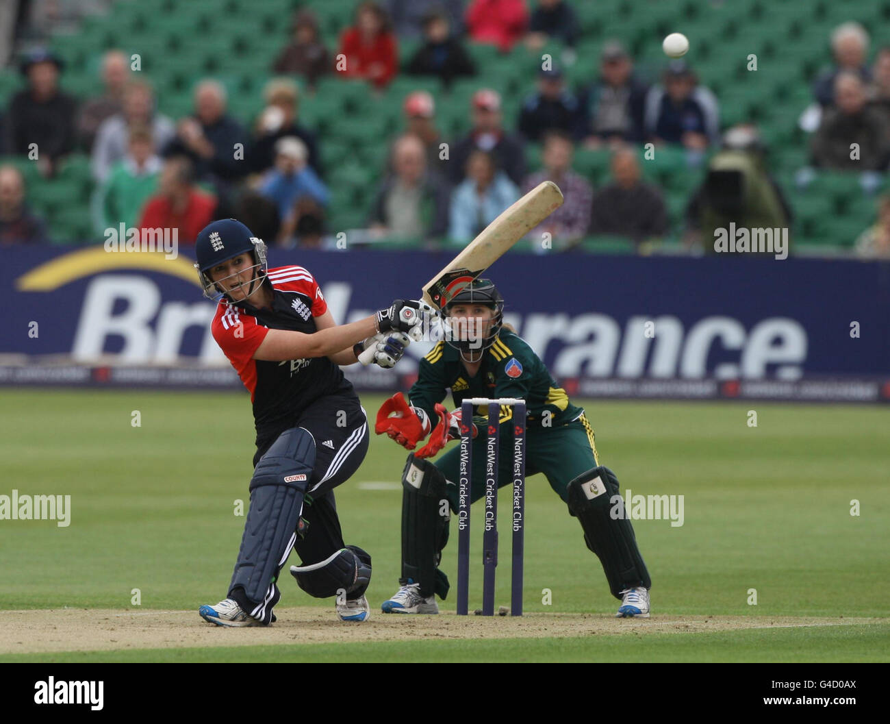 England Twenty 20 Women captain Charlotte Edwards scores watched by Australia wicketkeeper and captain Jodie Fields during the Quadrangular Twenty20 match at The County Ground, Gloucestershire. Stock Photo