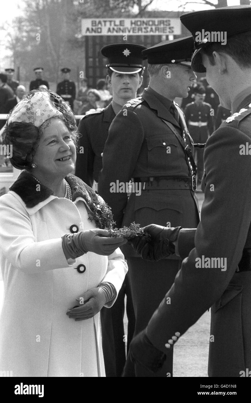 Queen Elizabeth the Queen Mother is seen handing shamrock to the officers when she visited the Irish Guards at Alexander Barracks. Each was given a sprig, so also was the regimental mascot, Fionn, an Irish Wolfhound (not pictured). The event dates from 1902 when Queen Alexandra started it. Even during the war, shamrock was distributed at various places abroad. Stock Photo