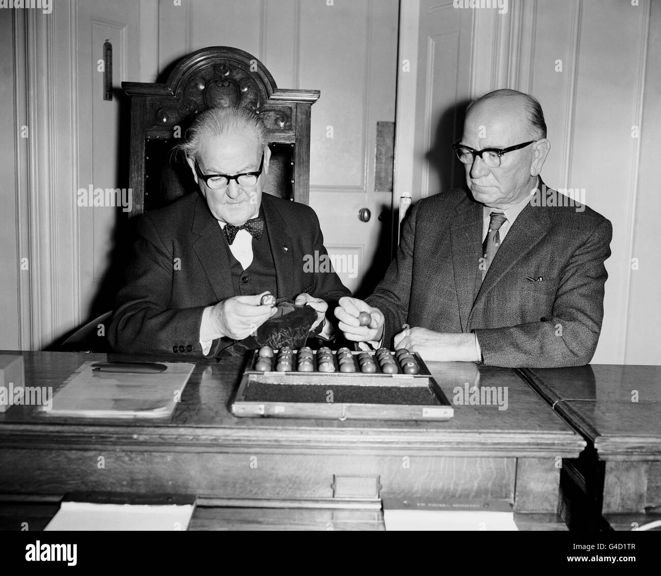 David Wiseman, left, Chairman of the FA Cup Committee and R.H Brough, Vice President of the FA, draw No. 27, Carlisle or Gravesend v No. 24 Sunderland. Stock Photo