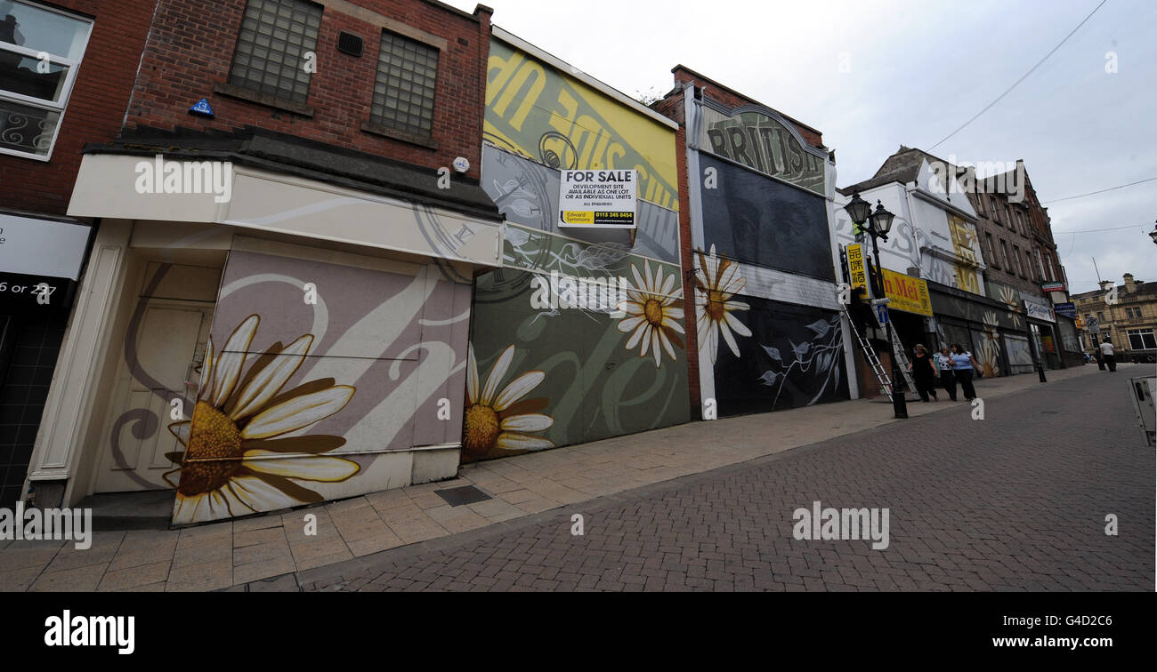 Boarded up shops and for sale signs in the High Street, Rotherham today as the retail sector of the UK economy reports difficult trading conditions. Stock Photo