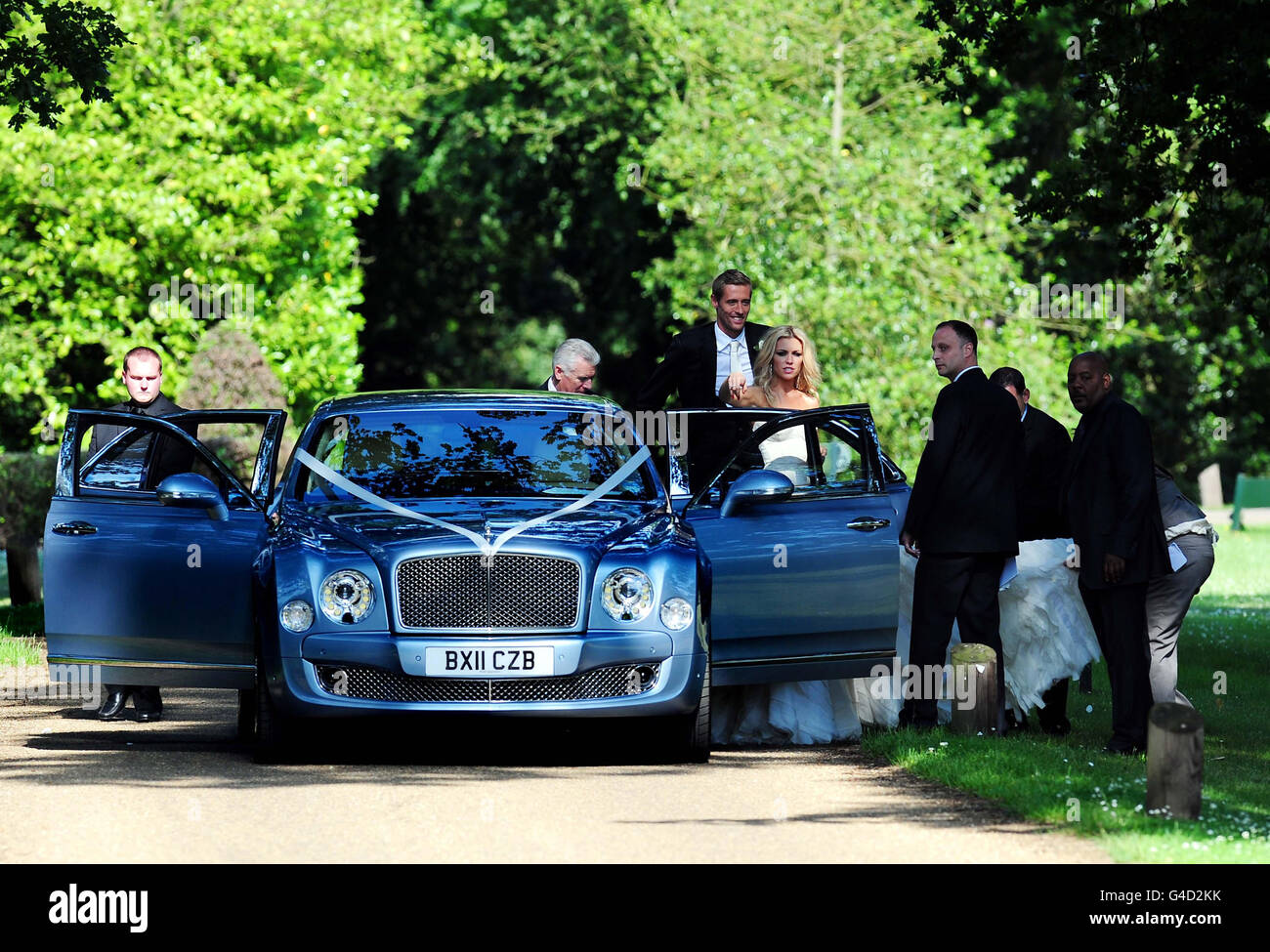 Footballer Peter Crouch and model Abbey Clancy, stand behind a door of a wedding car in the grounds of Stapleford Park in Leicester following their wedding. Stock Photo