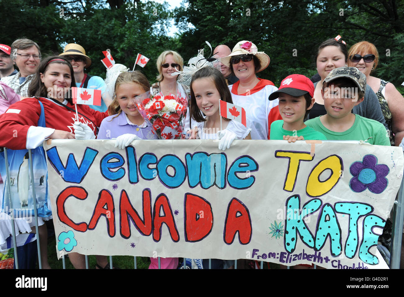 Families and well wishers outside Rideau Hall in Ottawa, Canada waiting patiently for the arrival of the Duke and Duchess of Cambridge, who are making their first official visit overseas since they were married. Stock Photo