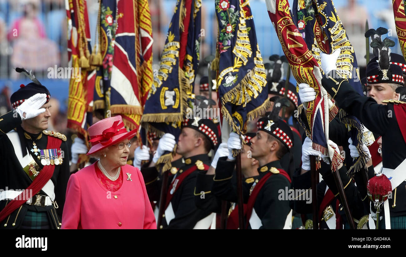Queen Elizabeth II as she presented the new Colours to the Royal Regiment of Scotland by symbolically touching the each Colour, during a ceremony at Holyrood Park in Scotland. Stock Photo
