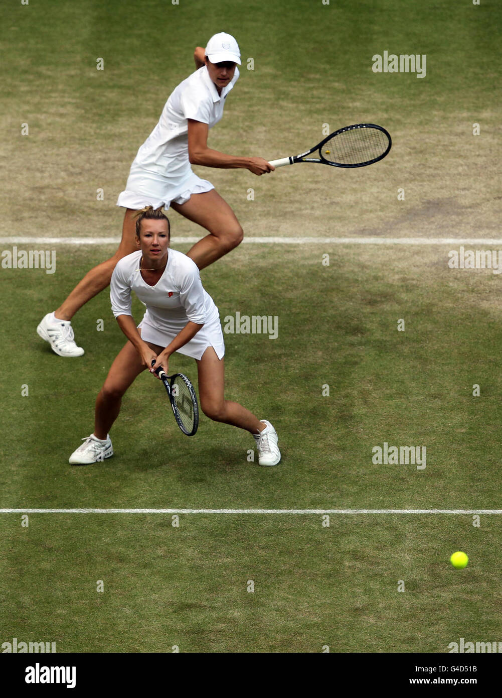 Czech Republic's Kveta Peschke (bottom) and Slovenia's Katarina Srebotnik (top) in action during their doubles match against Germany's Sabine Lisicki and Austria's Samantha Stosur in the ladies' doubles final on day twelve of the 2011 Wimbledon Championships at the All England Lawn Tennis and Croquet Club, Wimbledon. Stock Photo