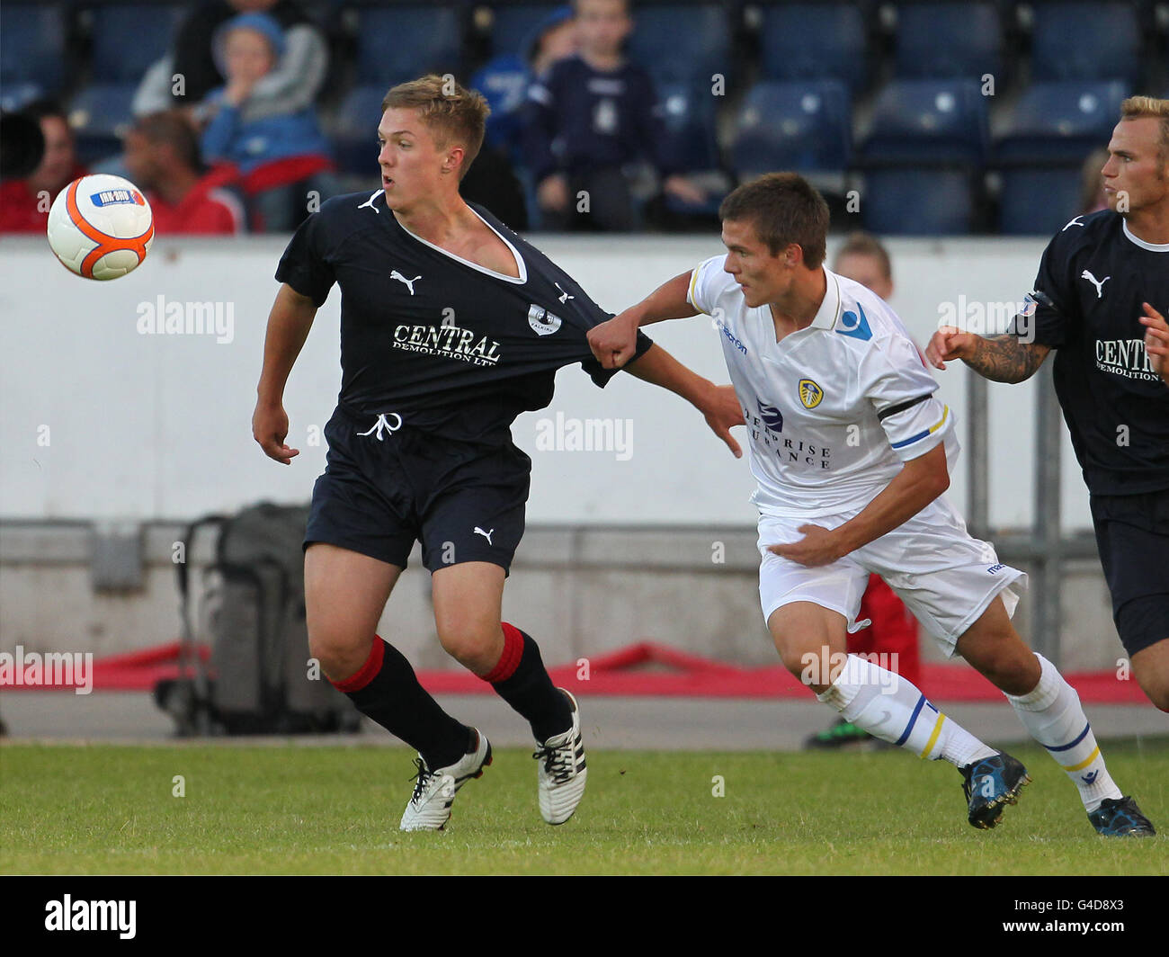 Falkirk's Mark Millar (left) and Leeds United's Ben Parker battle for the ball during the pre-season friendly at The Falkirk Stadium, Falkirk. Stock Photo