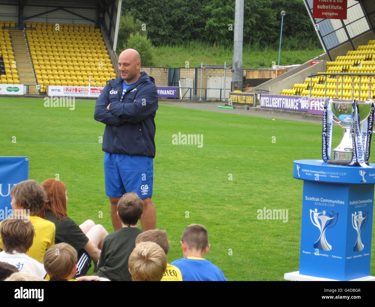 Livingston FC manager Gary Bollan talks to children attending a