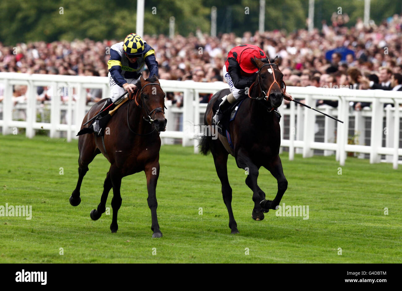 Talwar (left) ridden by Jimmy Fortune beats Trumpet Major ridden by Ryan Moore (right) to win the Jaguar XKR-S Winkfield Stakes during the Betfair Weekend at Ascot Racecourse, Ascot. Stock Photo