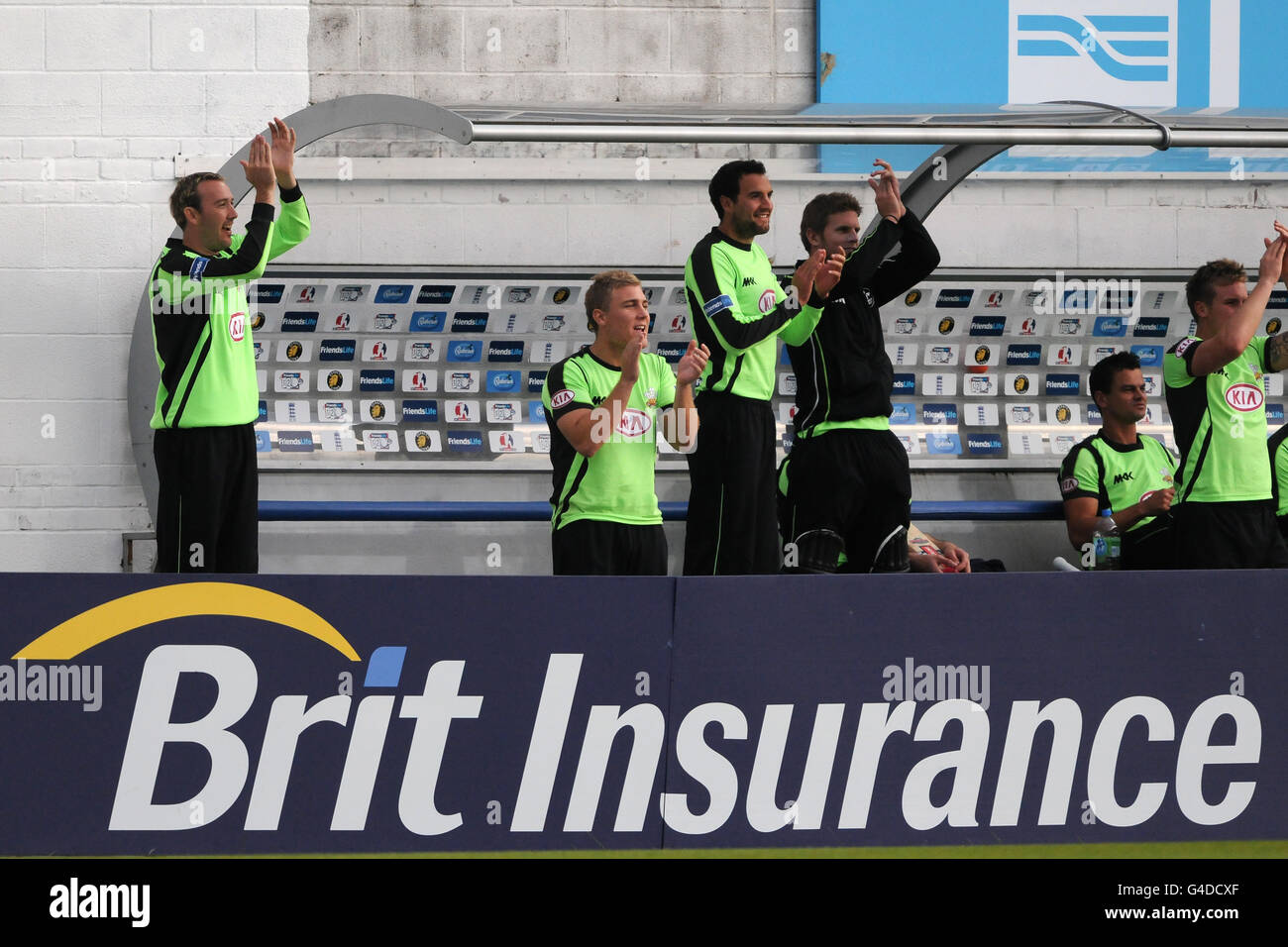 Surrey's Chris Schofield (left), Rory Hamilton-Brown, Matthew Spriegel (centre), Stuart Meaker (3rd right), Zander de Bruyn and Jason Roy (right) applaud their team mates from the dug-out Stock Photo