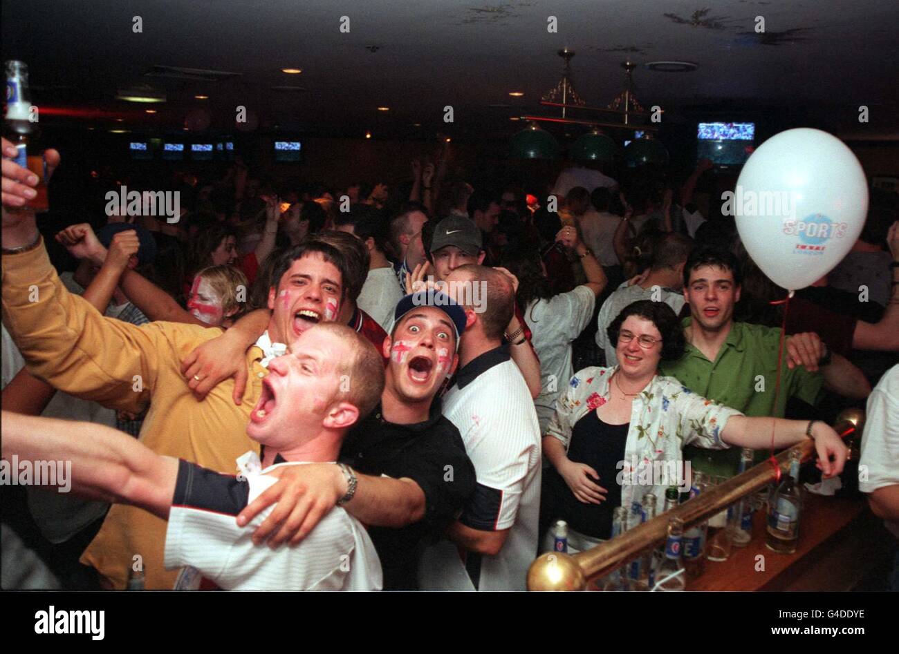 England fans celebrate at the Sports Cafe, in London's Haymarket tonight (Friday), following their 2-0 victory over Colombia in Lens. See PA story SOCCER Cup Bar. Photo by Rosie Hallam/PA Stock Photo