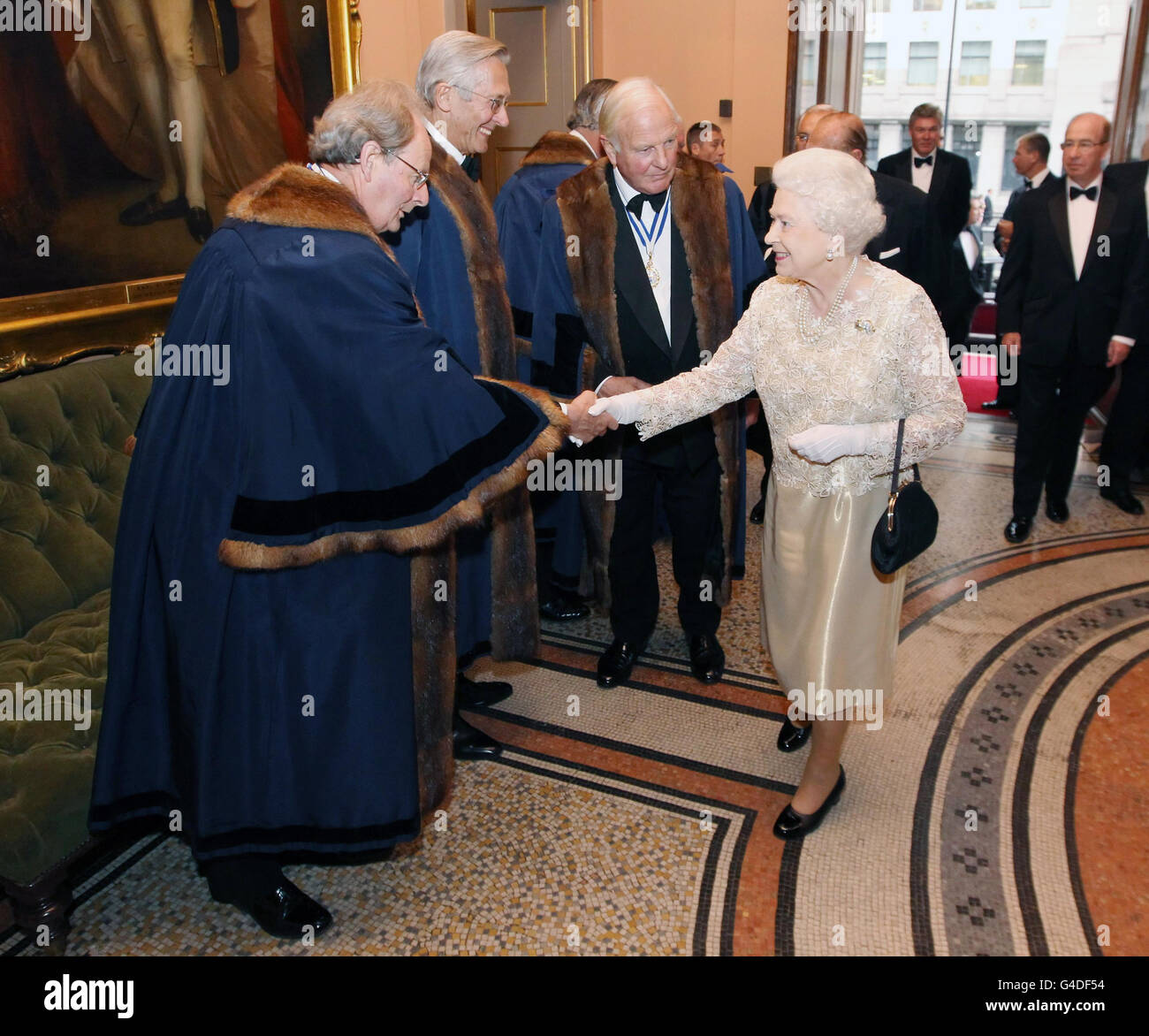 Britain's Queen Elizabeth II is greeted by the Wardens of Worshipful Companies as she arrives at Fishmongers' Hall, London, to attend a reception and dinner for Worshipful Companies, to mark the Duke of Edinburgh's 90th Birthday. Stock Photo