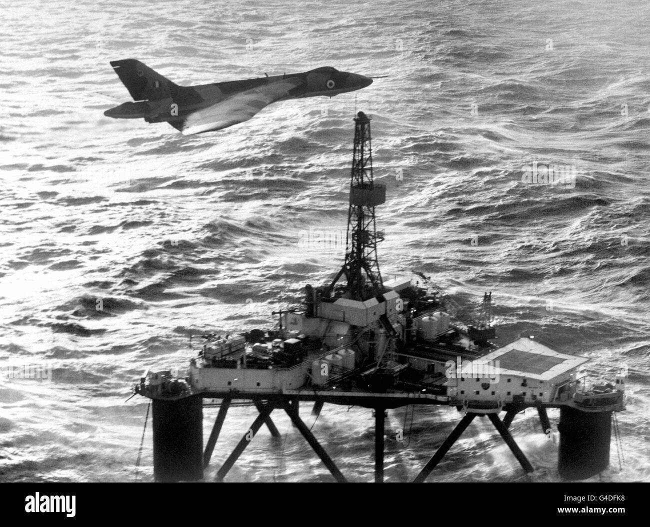An RAF Vulcan bomber checks all is well on a North Sea oil rig during a routine offshore patrol with a Hawker Siddeley Nimrod (not pictured) Stock Photo