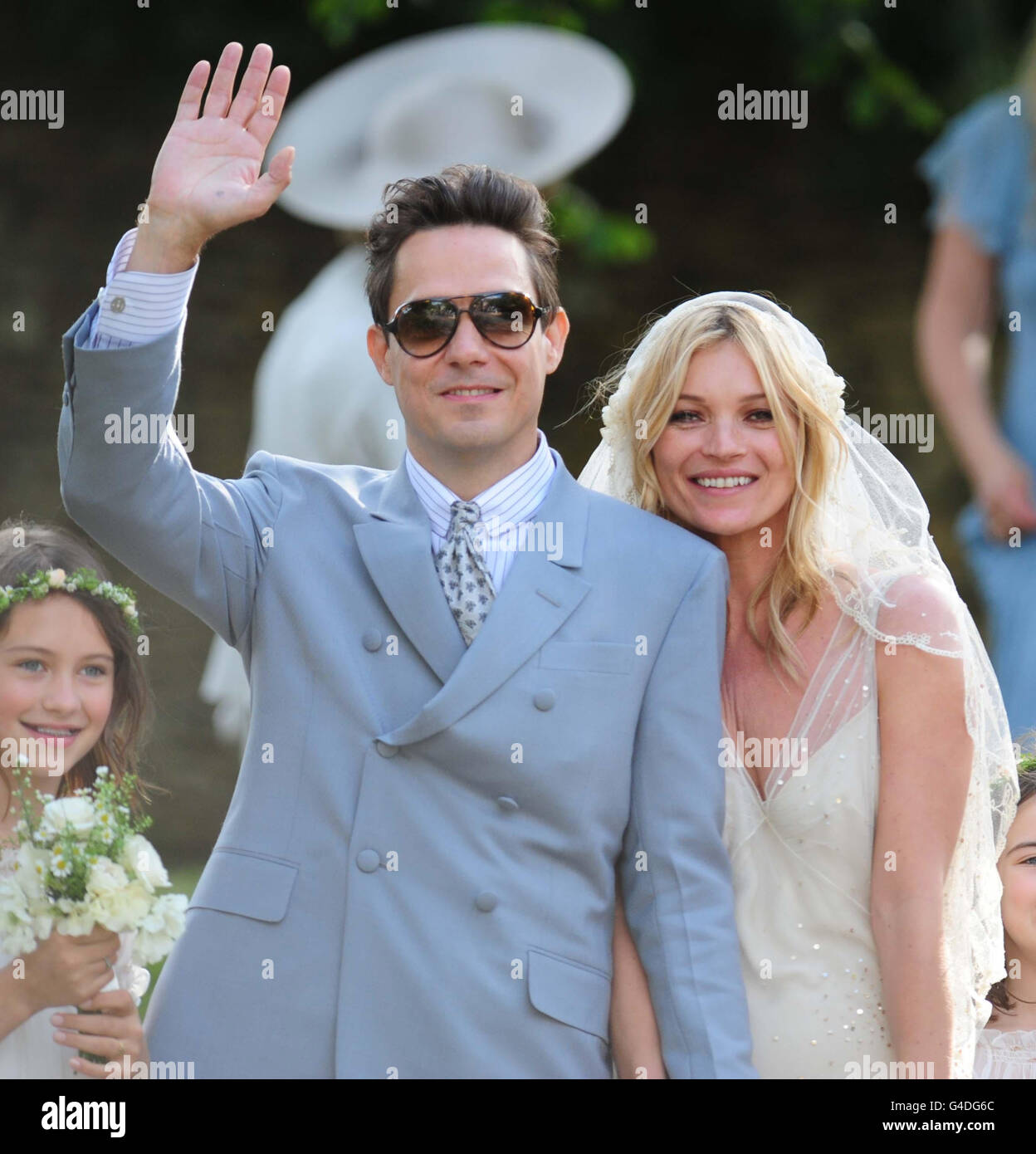 Kate Moss with her new husband Jamie Hince (left) after their wedding at St Peter's Church in Southrop. Stock Photo