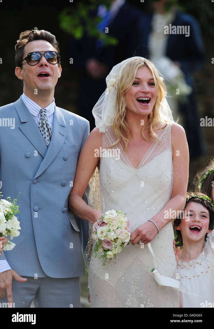 Kate Moss and Jamie Hince Wedding - Oxfordshire. Kate Moss with her new husband Jamie Hince (left) after their wedding at St Peter's Church in Southrop. Stock Photo