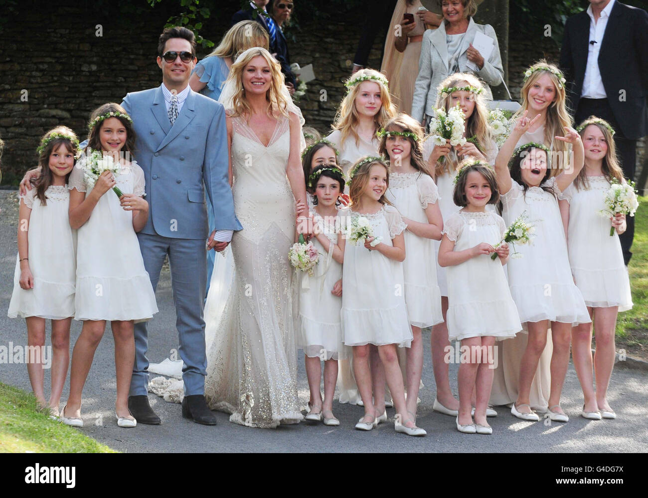 Kate Moss with her new husband Jamie Hince pose with bridesmaids after their wedding at St Peter's Church in Southrop. Stock Photo