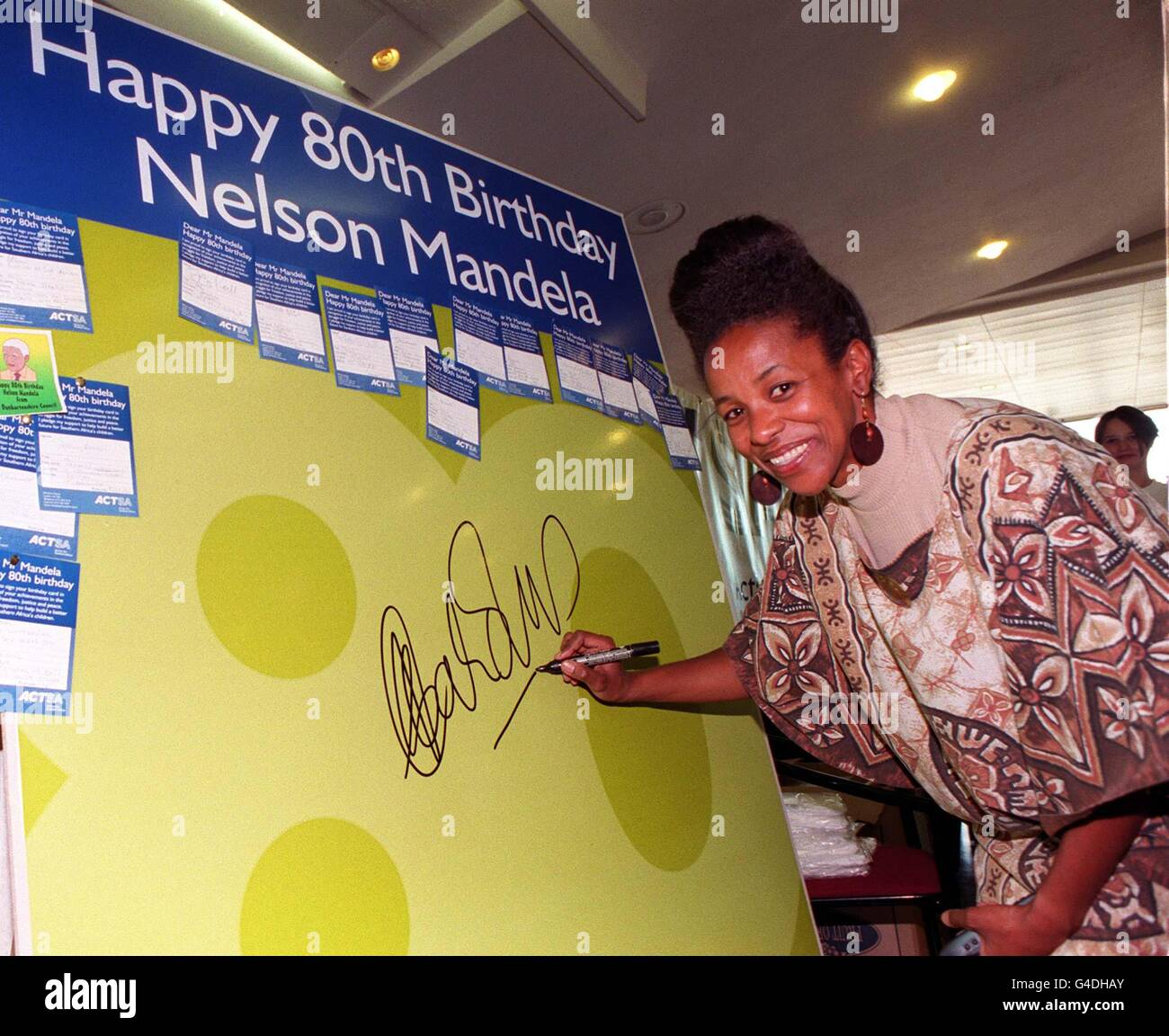 South African High Commissioner, Cheryl Carolus, is the first to sign a giant 80th Birthday card for President Mandela, at the Royal Festival Hall in London today (Sat). President Nelson Mandela married his long-time sweetheart Graca Machel today. Photo by Andrew Stuart. Stock Photo