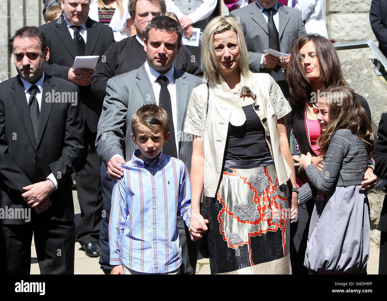 Family members stand following the funeral mass of david dunseith hi