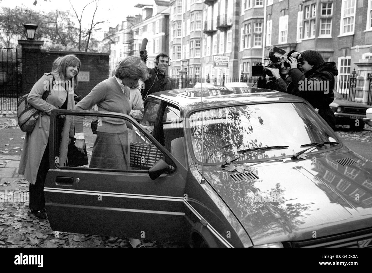 Lady Diana Spencer, surrounded by the media, leaving her Earl's Court flat in her bright new mini metro en route to her job as a teacher at a kindergarten in nearby Pimlico. Stock Photo