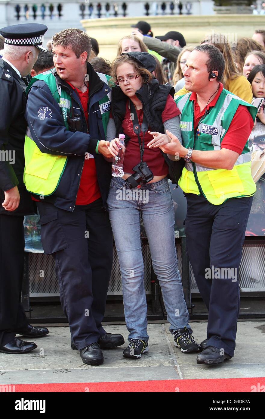 A fan gets pulled out of the crowd during the world premiere of Harry Potter And The Deathly Hallows: Part 2. Stock Photo