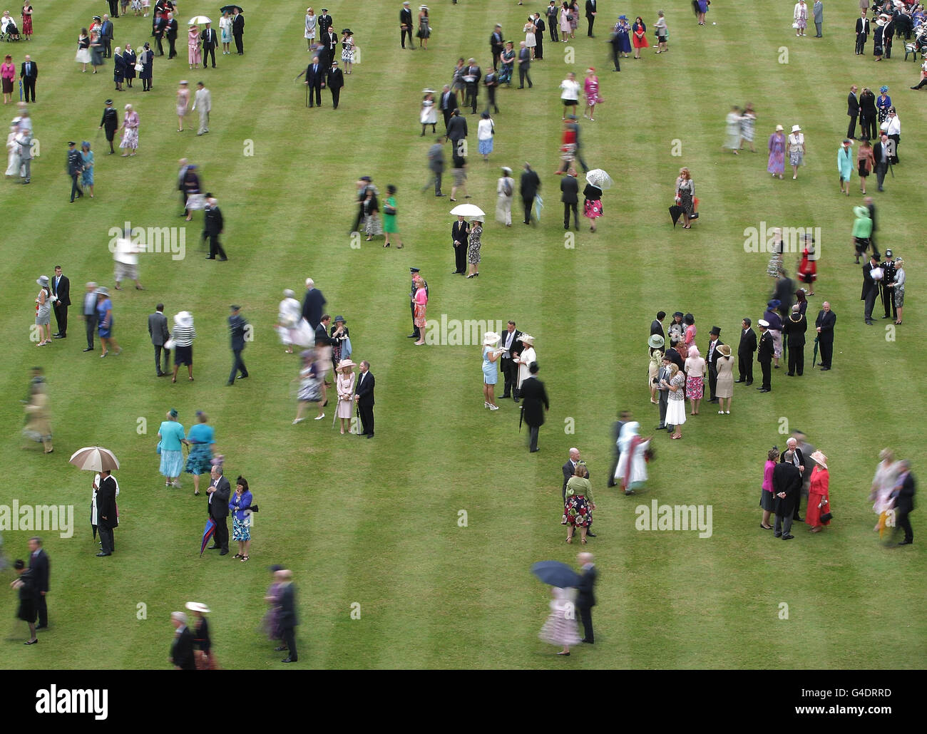 Guests attend a royal garden party at buckingham palace hires stock
