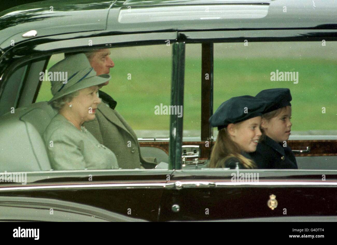 The Queen and Duke of Edinburgh with their grandchildren Princess Beatrice and Princess Eugenie (right) leaving Balmoral castle this morning (Monday) en route to Crathie Kirk church for memorial in memory of Diana, Princess of Wales. Stock Photo