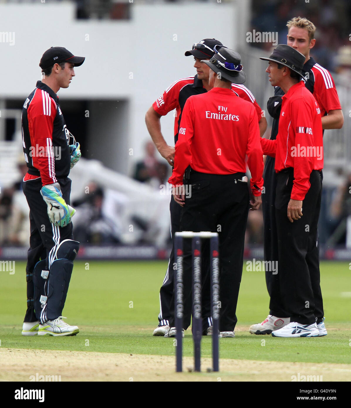 England captain Alastair Cook and wicket keeper Craig Kieswetter talks to umpires Billy Bowden and Nigel Llong during the Natwest third One Day International at Lords, London. Stock Photo