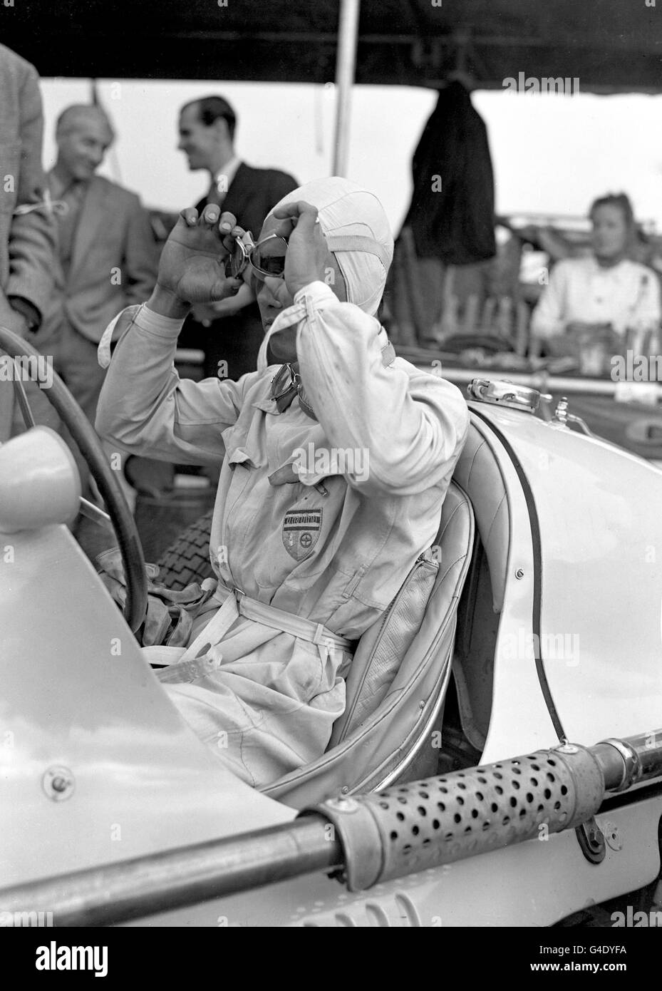 Formula One Motor Racing - RAC International British Grand Prix - Silverstone. Thai Prince Bira adjusts his goggles before the race Stock Photo