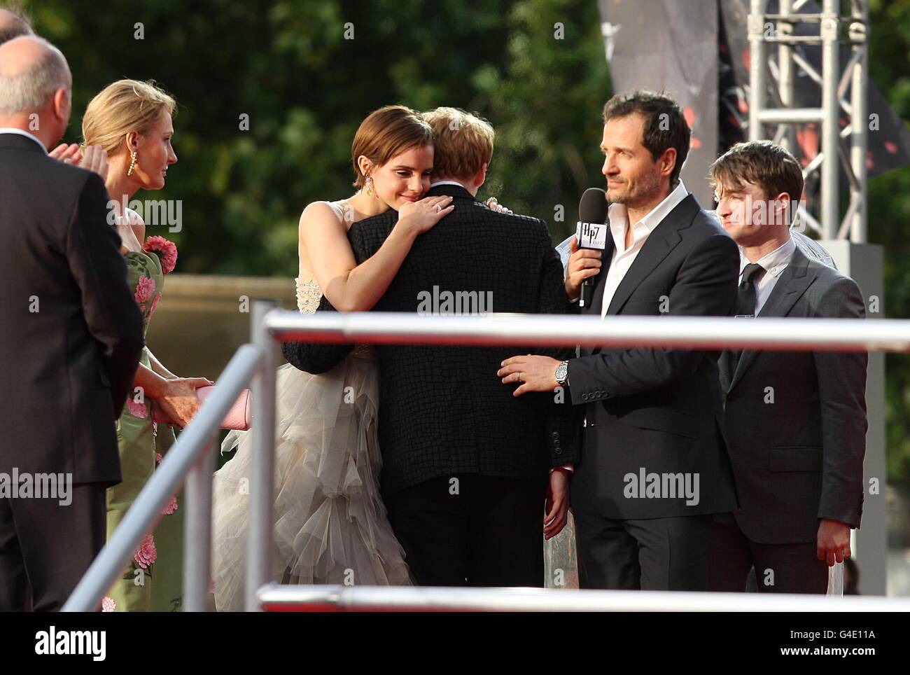 (L-R) Emma Watson hugs Rupert Grint at the world premiere of Harry Potter And The Deathly Hallows: Part 2. Stock Photo