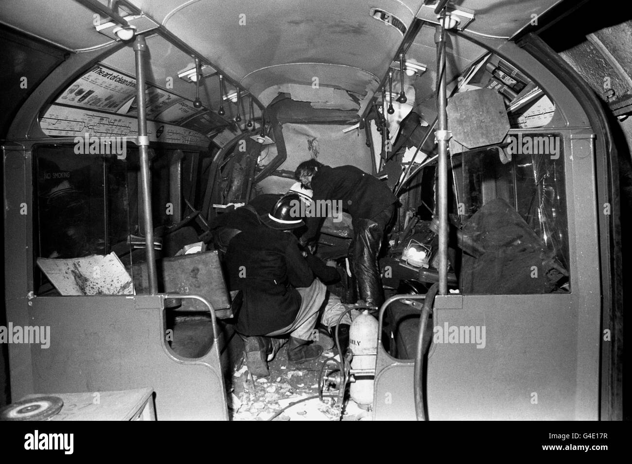 Forty-three people were killed after a tube train crashed through buffers and into an end wall. The photograph shows fireman at work in one of the coaches of the six-carriage London Underground train which overran the platform and entered a blind tunnel at Moorgate Station in London. Stock Photo