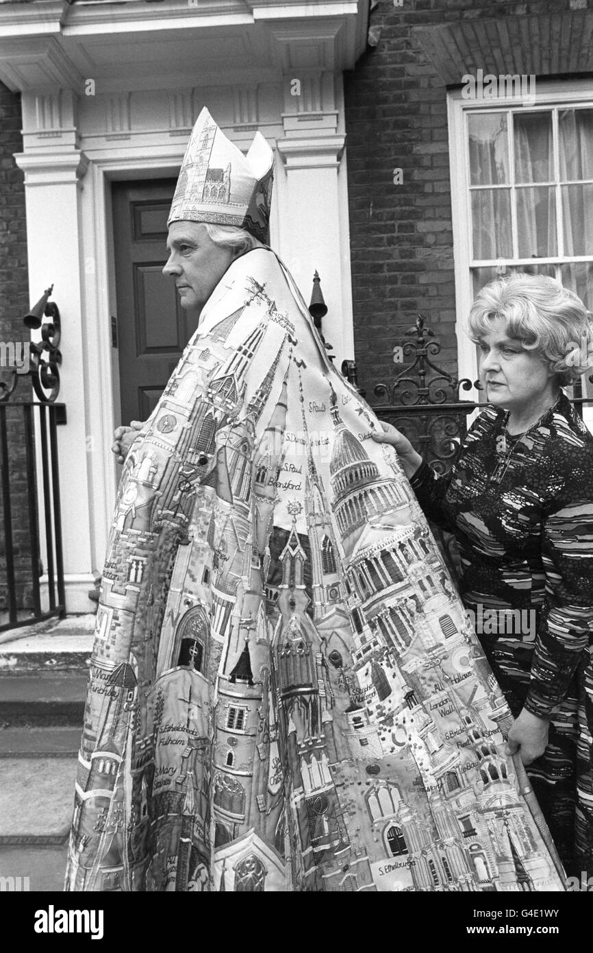 The Bishop of London, the Rt Rev Gerald Ellison, in the new cope and mitre he will use for the first time at the Silver Jubilee service to be attended by the Queen in St Paul's Cathedral. With him is the designer, Beryl Dean, who made the cope with her students at the Stenhope Adult Education Institute in London. They have donated it to the City of London for the Bishop's use. The design includes St Paul's cathedral, 73 churches of the London Diocese, three Royal Peculiars and one house - no.42 Queen's Square, where the classes were held. The embroidery, on a fine cream coloured woollen Stock Photo