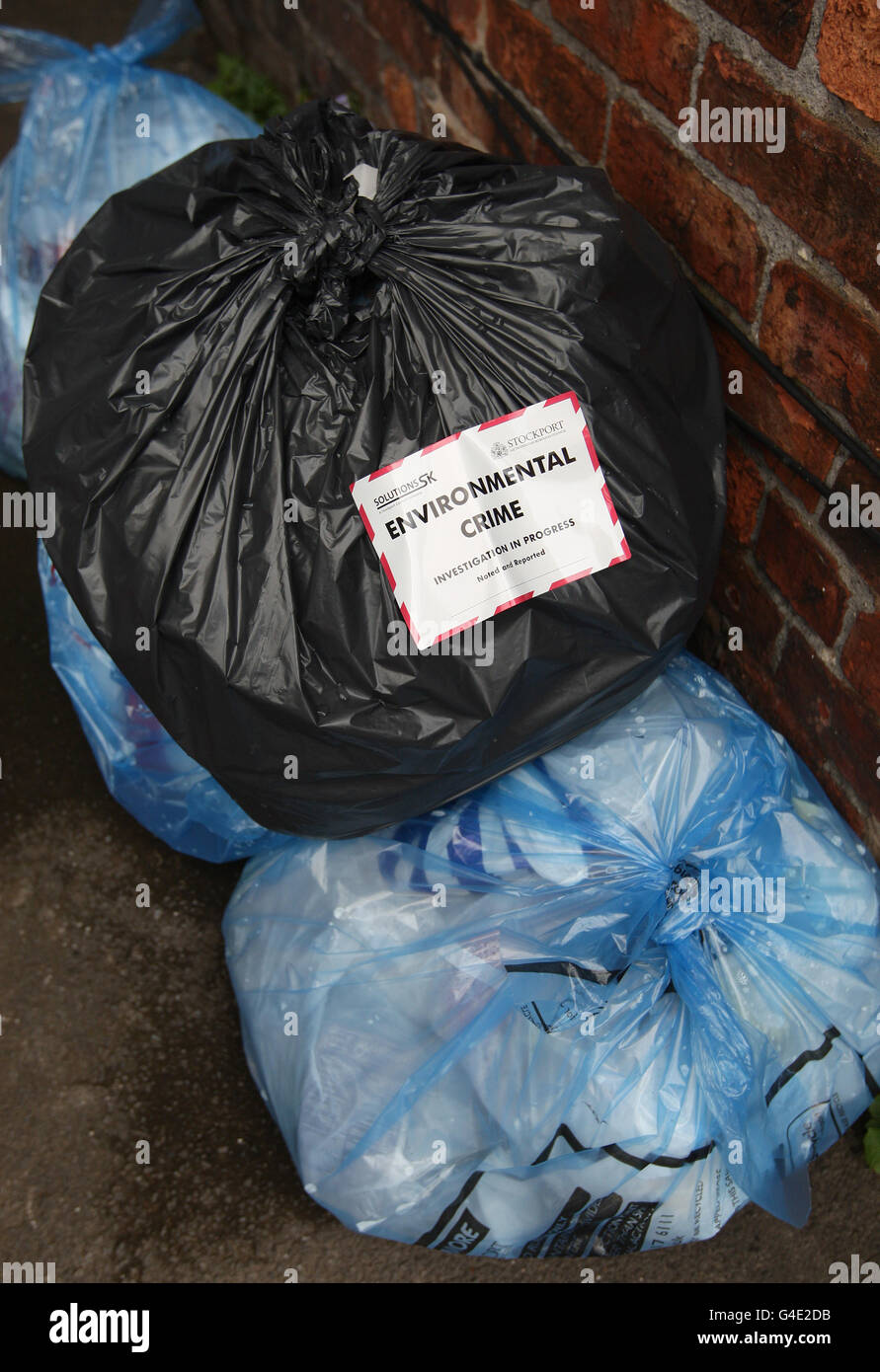 Sticker on refuse sacks filled rubbish on street in stockport hires stock photography and
